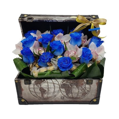 Blue roses,orchids and chocolates in a chest