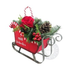 Red wooden sleigh with festive arrangement