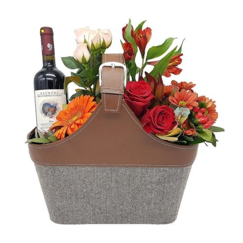 Flowers and wine in leather handbag