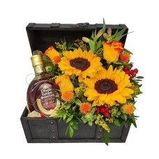 Dimple and yellow|orange flowers in a wooden chest