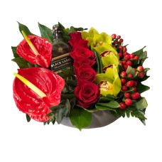Floral arrangement with a bottle of whiskey