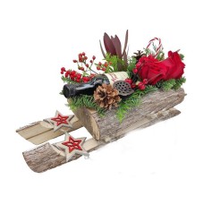 Flowers arranengment in wooden sleigh and wine