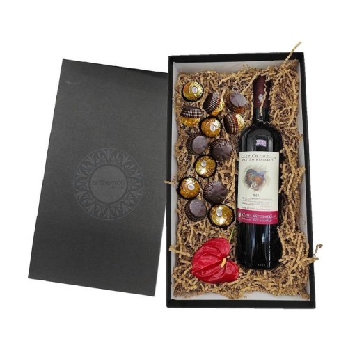 Gift box with red wine and chocolates
