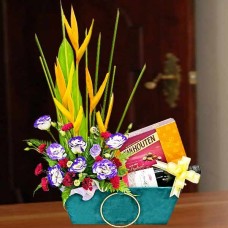 A Bottle of Red Wine with Chocolates and Flower Arrangement in a basket.