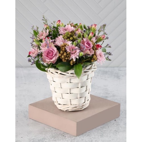 Pink And Purple Blooms In A White Basket
