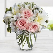 Arrive In Style (4 stems of Peach roses with 2 stems of white lilies, 2 stems of white alstroemeria and 2 stems of chrysanthemums in a cube Glass vase. (one sided round arrangement))