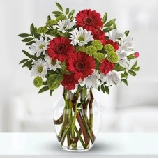 Istant Smile (3 Red Gerberas, 2 stems of White Alstroemeria, 5 Red Carnations, 2 stems of Green button chrysanthemums, 2 stems of white chrysanthemums in a Glass Vase)