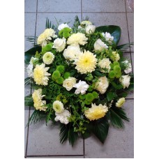Round-shaped funeral arrangements in creamy, white and green tones
