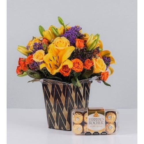 Arrangement of yellow Lilys and Ferrero 16