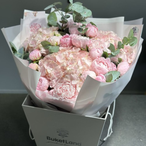 A bouquet of peonies and hydrangeas in a designer design in a box