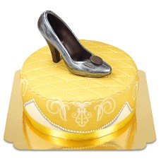 Golden deluxe cake with chocolate shoe and ribbon