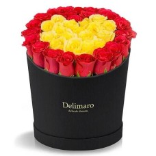 Red and yellow roses heart shaped in a black box