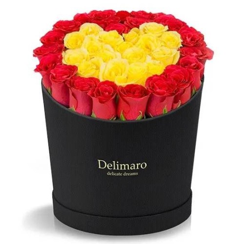 Red and yellow roses heart shaped in a black box